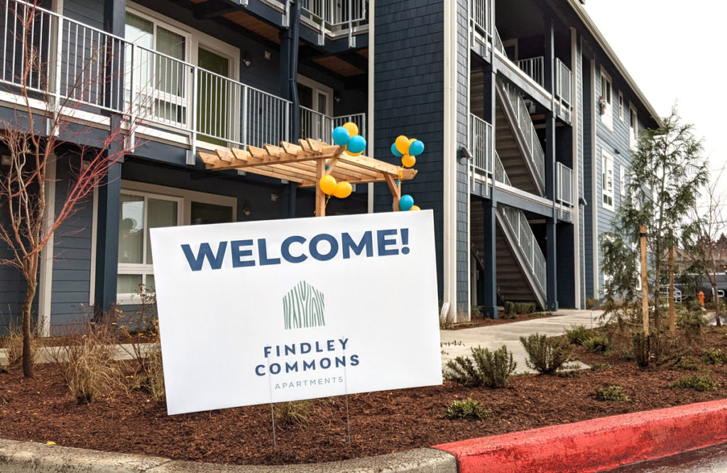 View of newly completed Findley Commons housing development with WELCOME sign in foreground